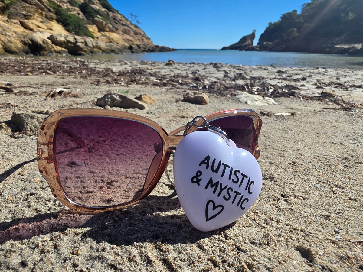 Original Autistic and Mystic charm beside sunglasses on Mallorca beach